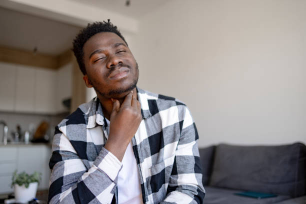 young african american man feeling sick at home - boğaz ağrısı stok fotoğraflar ve resimler