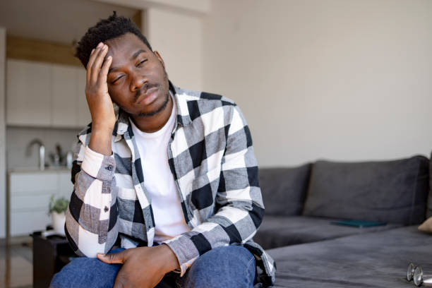 istock Young African American man feeling sick at home 1386885349
