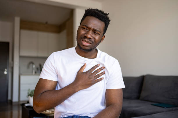 istock Young African American man feeling sick at home 1386885378