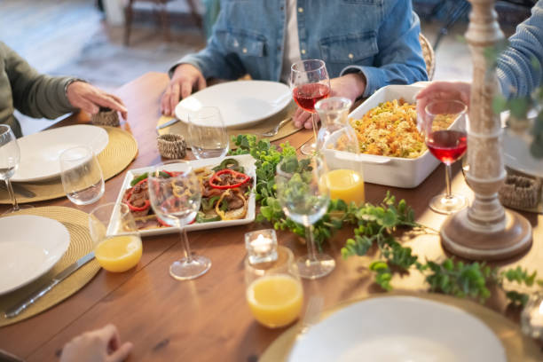 istock Family sitting at table having dinner together 1386885819