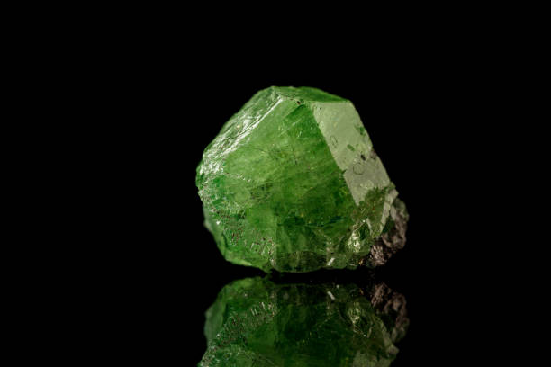 istock macro mineral stone Demantoid on a black background 1386886767