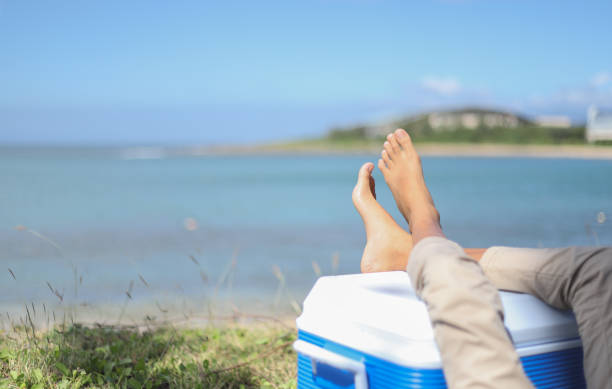 a Asian girl's feet up on \nthe beach. background for travel.