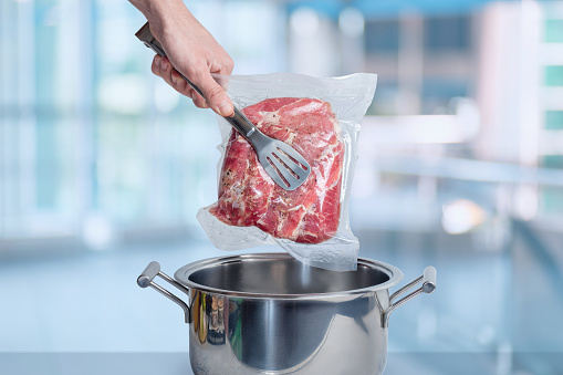 Cooking meat vacuum packed with sous vide technology.