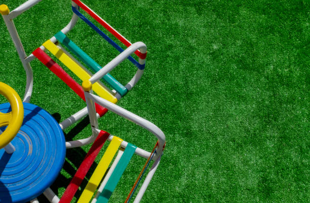 children's merry go round with several seats something old very colorful,on the left side on the grass with space for text