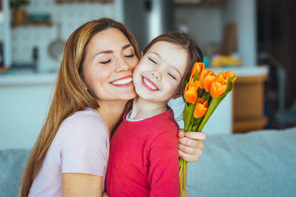 istock Mum and girl smiling and hugging. 1386892632