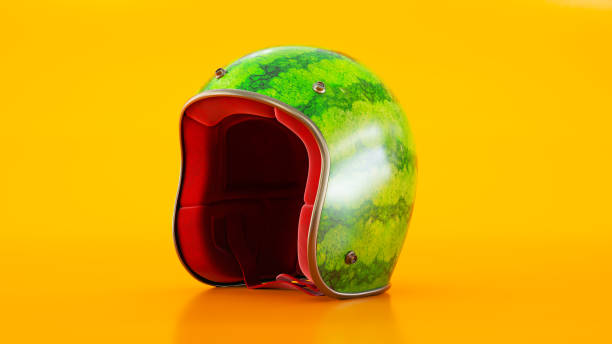 istock helmet as water-melon isolated on orange background, 1386892772