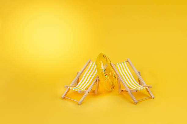 istock Two beach chairs and yellow swimming ring 1386892938