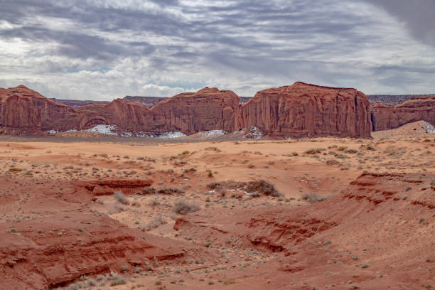 istock Scenic view with dramatic clouds from dirt road in Monument Valley made famous by western movies 1386895532