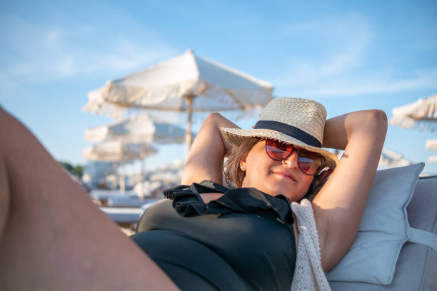 istock A young woman is lying on a deck chair on a luxury beach 1386895540