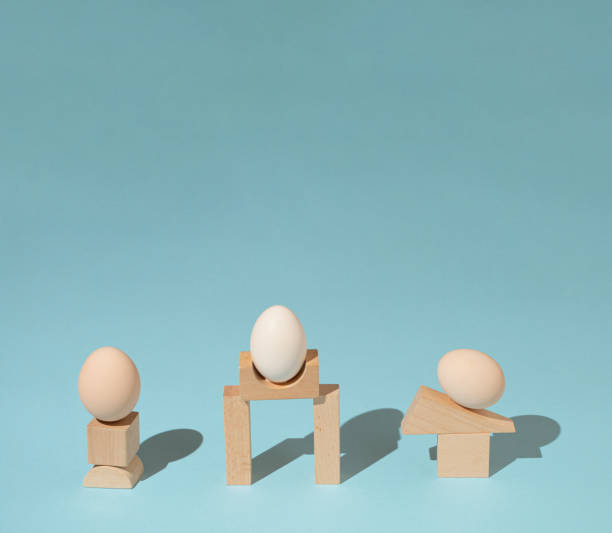 istock Trendy sunlight composition made with eggs and wooden geometric elements onpastel blue background. Minimal architectural concept. 1386895630