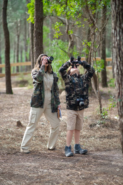 istock Mother and son getting ready to take pictures in forest 1386897041