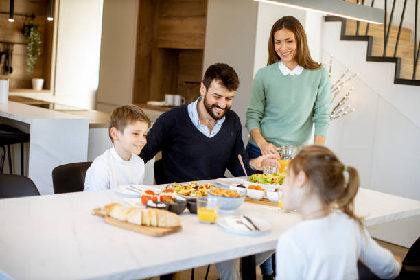 istock Young mother preparing breakfast for her family in the kitchen 1386900539