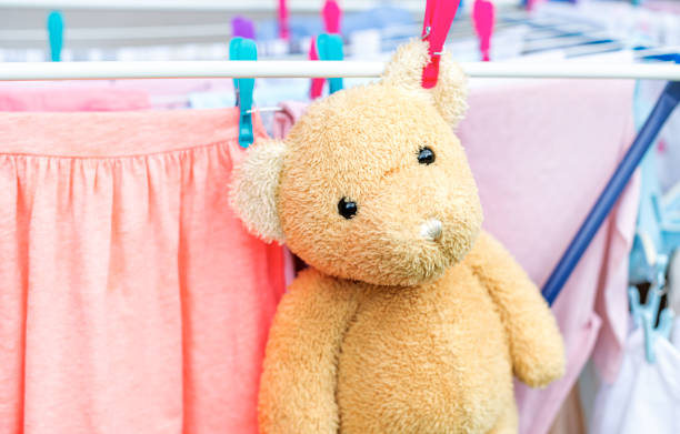 The teddy bear soft toy dries after washing along with other laundry.