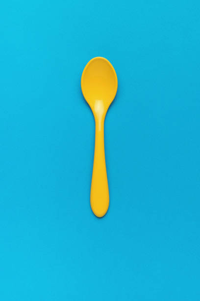 istock A small children's plastic spoon on a blue background. Flat lay. 1386901834