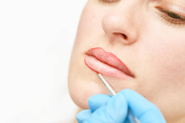 istock Permanent makeup. Beauty spa procedure. young woman. Face tattoo 1386903785