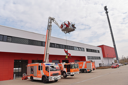 Firetrucks exiting airports fire department garage for an emergency at the airfield runway-