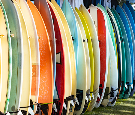 Multicolored surfboards standing on a board rack in Hawaiian Beaches, Hawaii, United States