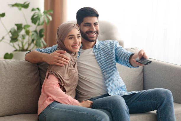 istock Contented Middle Eastern Spouses Watching Movie On TV At Home 1386905865