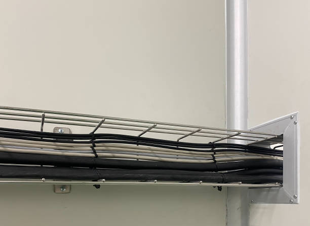 Several cable electric  are placed on stainless steel tay way attached to the walls of the room. The wires are kept organized and safety. stock photo