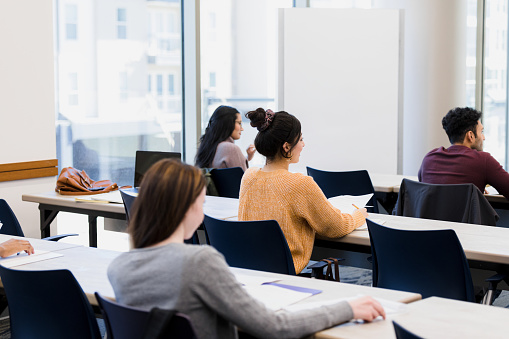 The classroom is full of young adults eager to receive the results of their completed exam.