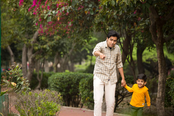 istock Father with son walking at park 1386911768