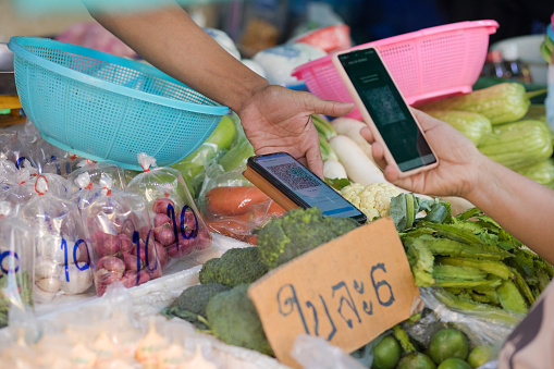 QR code contactless payment at vegetable market stall on local market in Bangkok Chatuchak