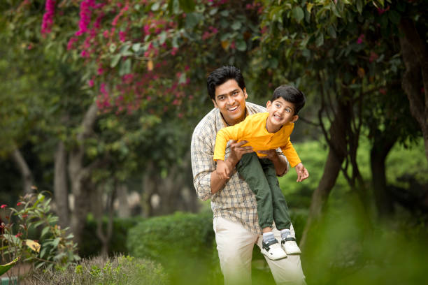 istock Father having fun with cute son at park 1386911983