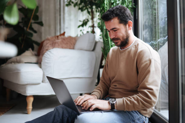 istock Young man working at home in the evening 1386912982