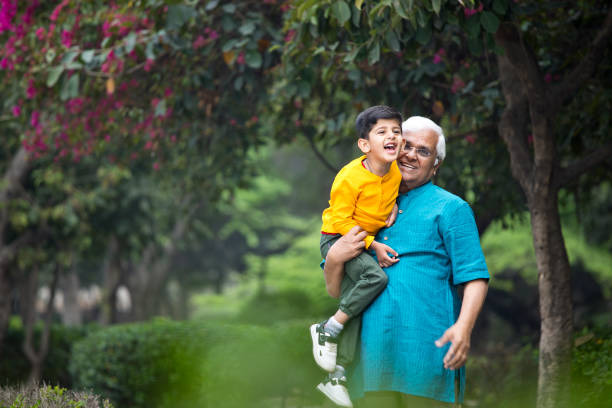 istock Old man enjoying with grandson at park 1386914893