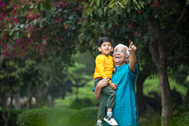 istock Old man enjoying with grandson at park 1386914933