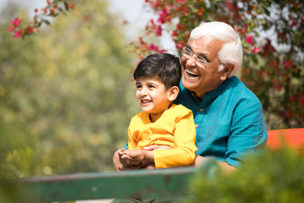 istock Little boy spending leisure time with his grandfather at park 1386917095