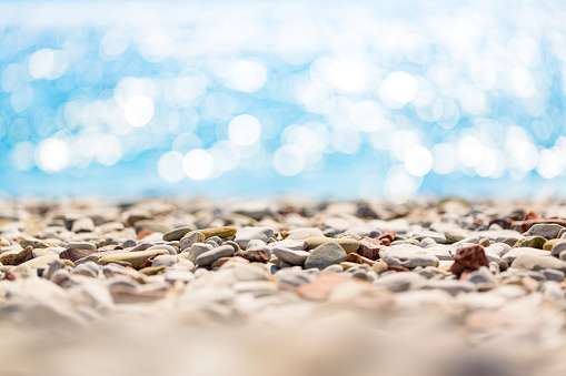 Pebbles close up with defocused sea background