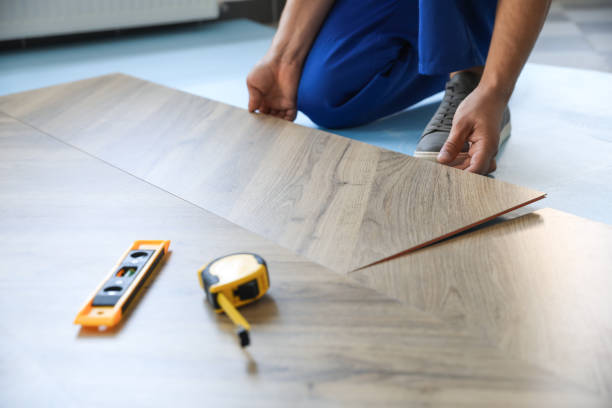 istock Worker installing laminated wooden floor indoors, closeup 1386919806