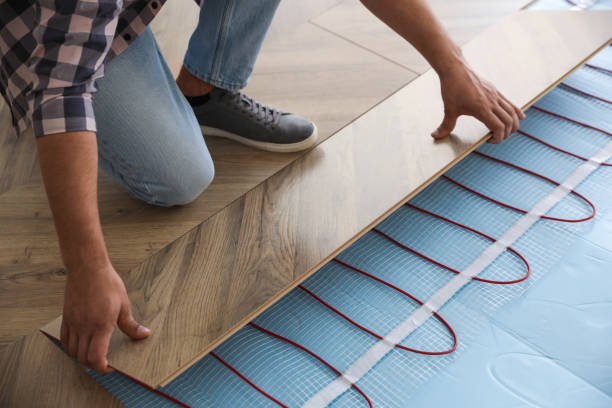 istock Professional contractor installing underfloor trace heating system indoors, closeup 1386919854