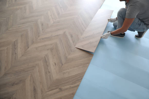istock Worker installing laminated wooden floor indoors, closeup 1386920002