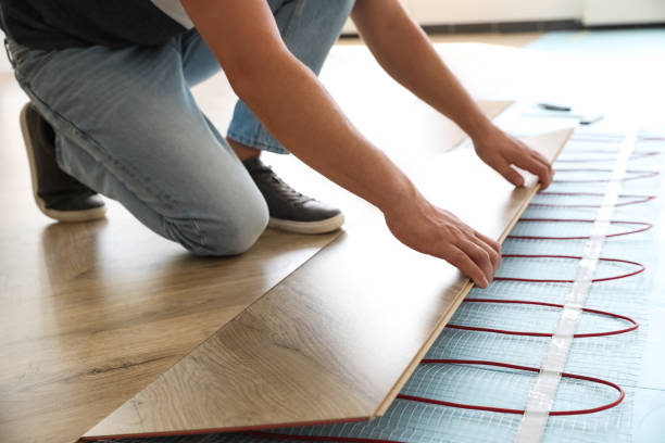 istock Professional contractor installing underfloor trace heating system indoors, closeup 1386920131