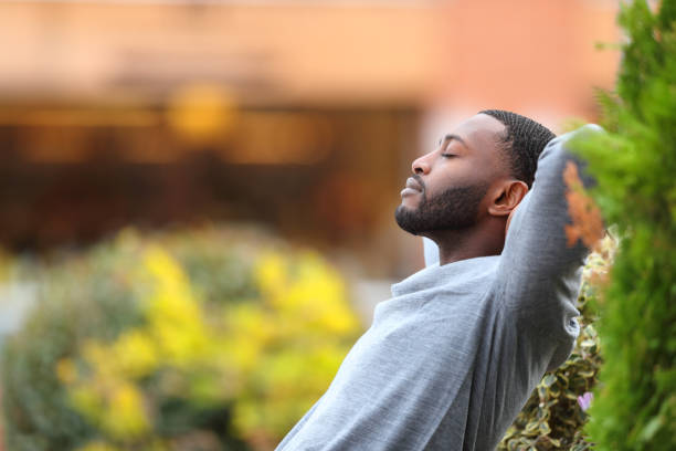 istock Relaxed man with black skin resting in a park 1386921862