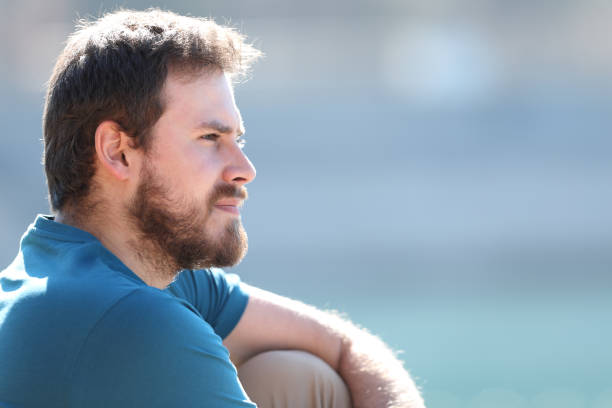 istock Pensive relaxed man contemplating views sitting in a lake 1386922002