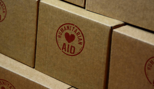 Humanitarian Aid and help stamp and stamping Humanitarian Aid stamp printed on cardboard box. Help refugees, volunteering and rescue during the crisis concept. humanitarian aid stock pictures, royalty-free photos & images