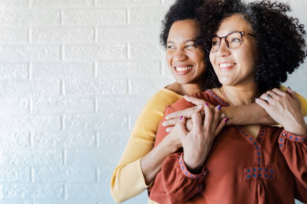 istock Gay couple hugging and looking away 1386923689