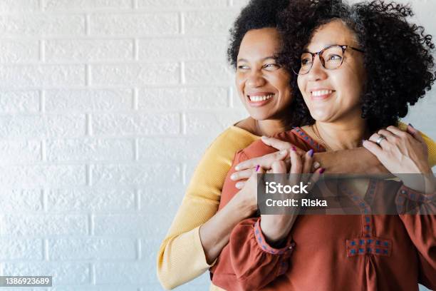 Gay Couple Hugging And Looking Away Stock Photo - Download Image Now - Couple - Relationship, Lesbian, Multiracial Group