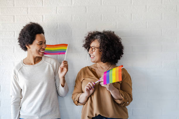 istock Lesbian couple holding rainbow flags 1386923926