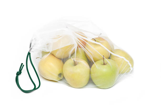 istock Apples in a reusable bag on a white background. Zero waste concept 1386924173