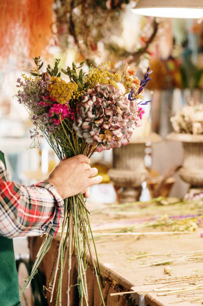 istock Crafting a bouquet in a flower workshop 1386924176