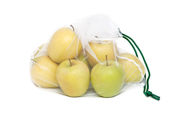 istock Zero waste concept. Apples in a reusable bag on a white background. 1386924185