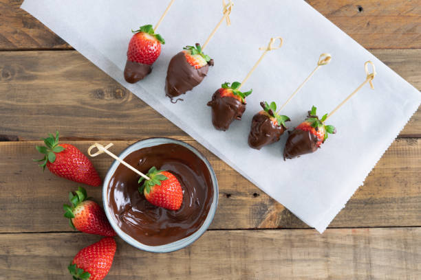 istock Strawberries with chocolate on a wooden background. Copy space. 1386925577