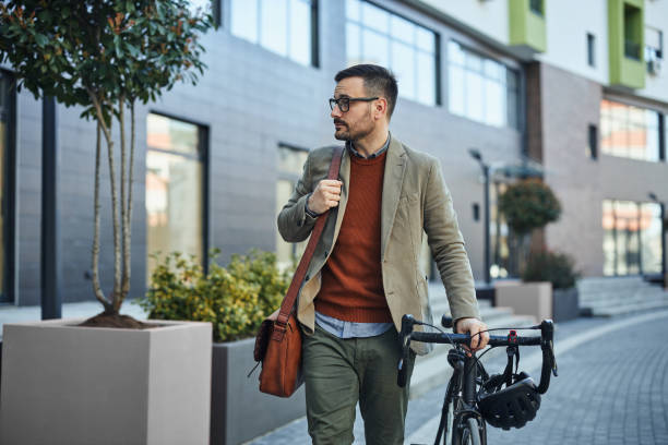 istock Businessman commuting to work with his bicycle 1386928556