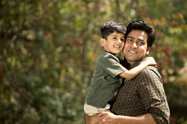 istock Cheerful father with cute little son at park 1386929010