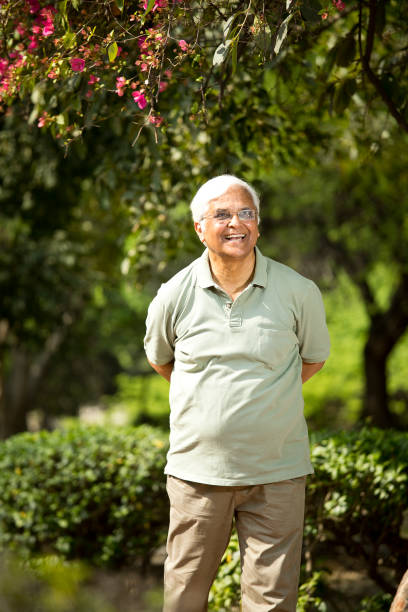 istock senior man walking at park 1386931009