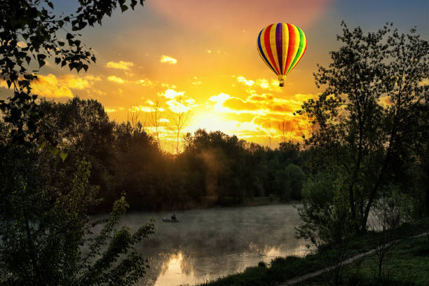 A hot air balloon in the sky on the background of bright sunset.